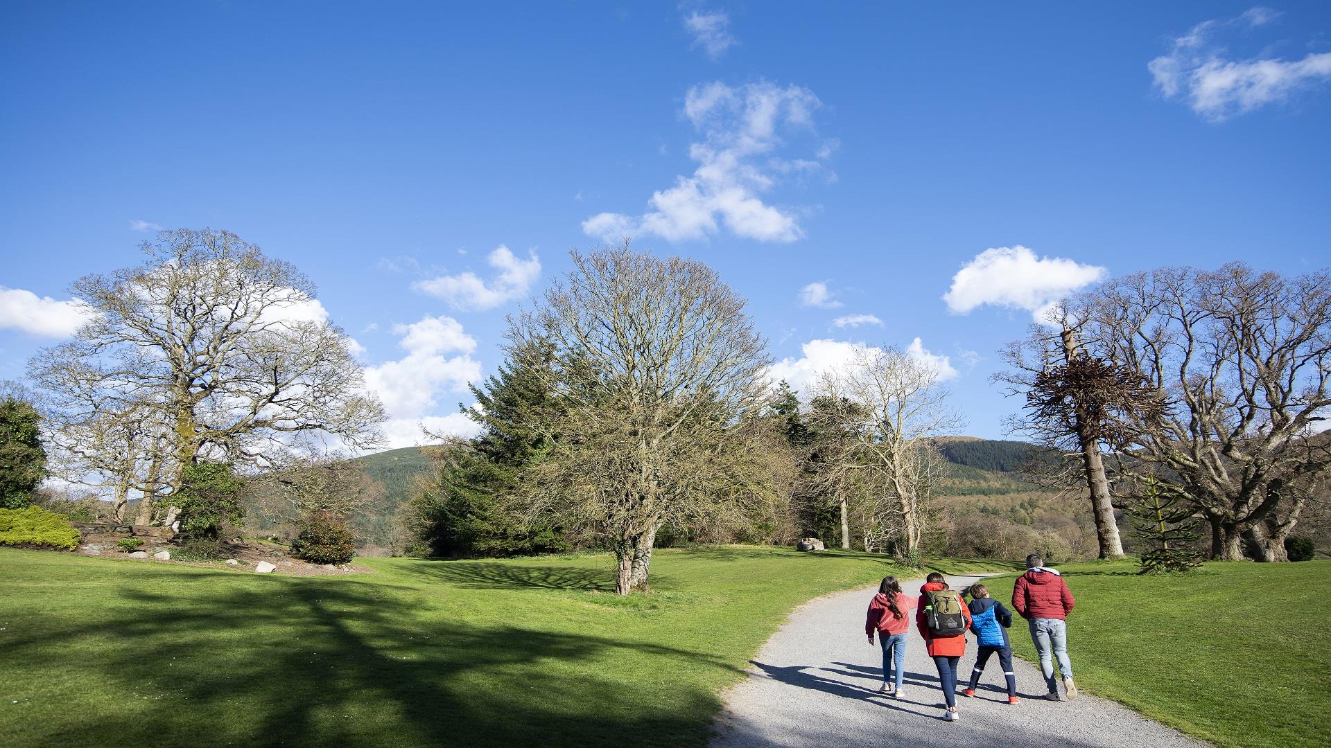 Family walking in Kilbroney Park on a beautiful, sunny day