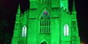 Down Cathedral, Downpatrick lit up green to celebrate St Patrick's Festival.