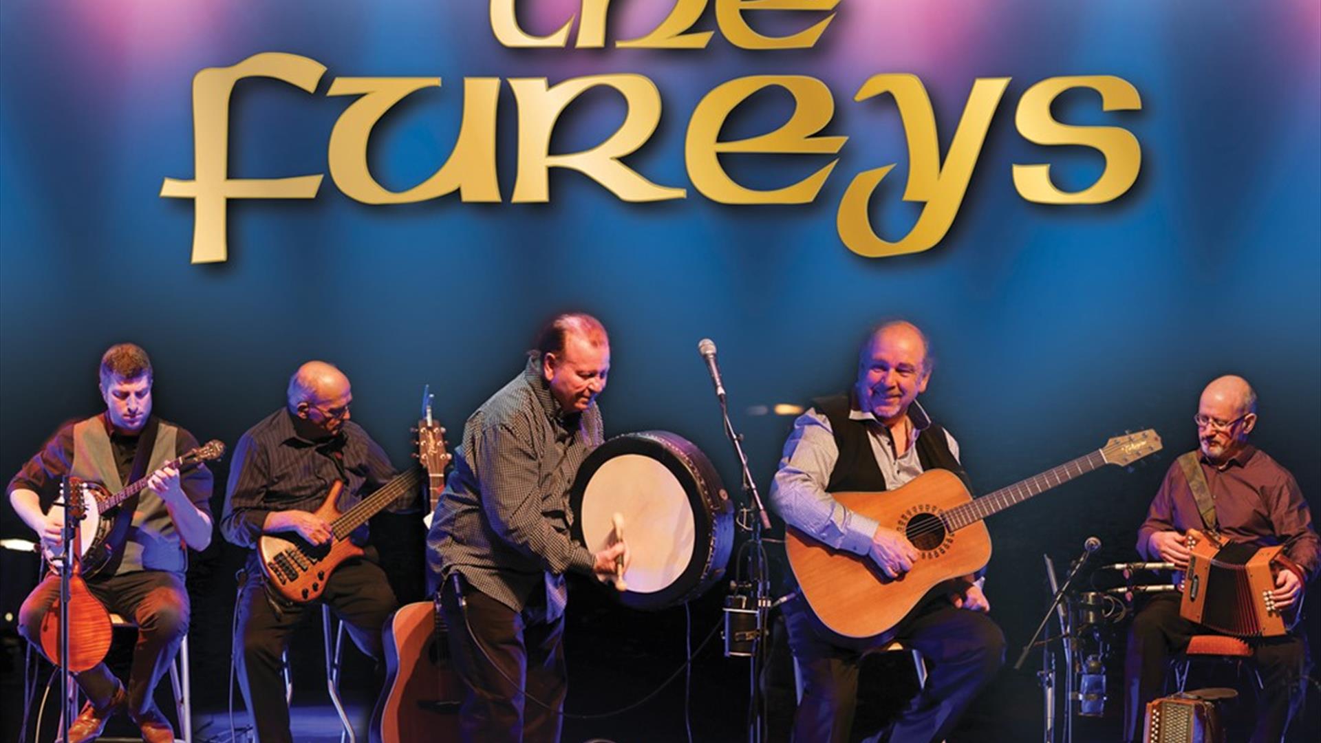 The Fureys band on stage with musical instruments