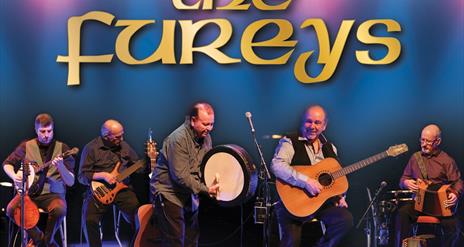 The Fureys band on stage with musical instruments