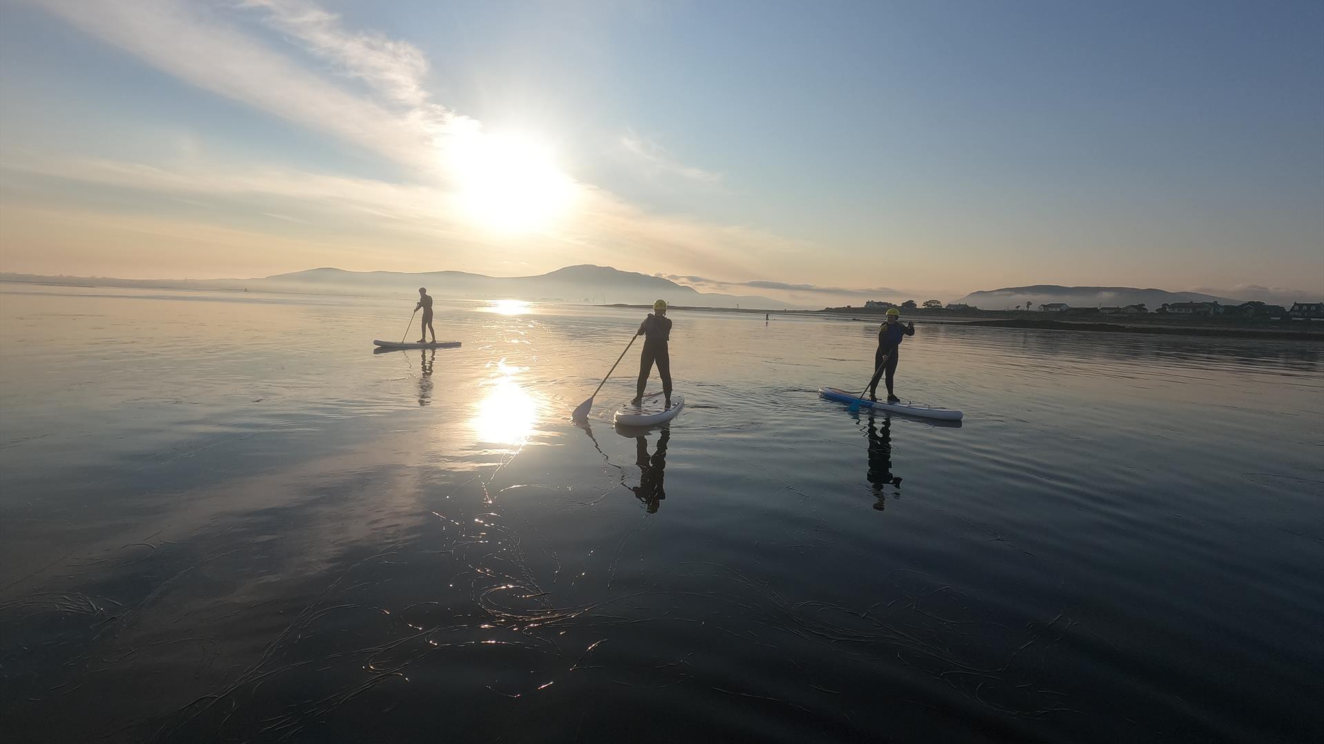 floating into the sunset at Greencastle beach, mourne mountains