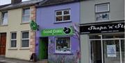 Pictured is the front of Belinda's Good Craic Gifts and Souvenirs shop. On the front is a graphic of a black sheep and also a green sheep.  Front of t