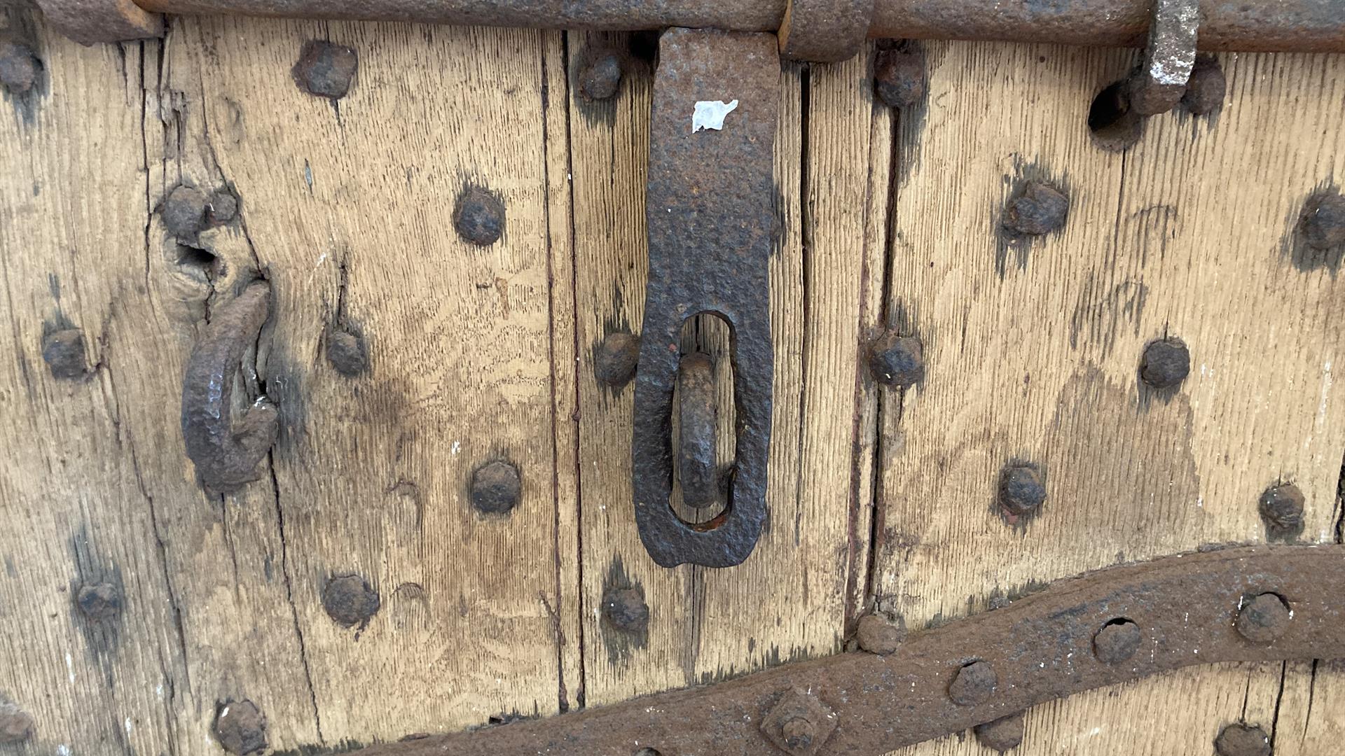 Section of a door from the olg gaol, now the Down County Museum. It features metal bars and reinforcing nails  to strengthen it.