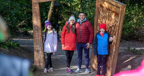 A family getting their picture taken as they walk through the wardrobe at the start of the Narnia Trail in Kilbroney Park, Rostrevor.
