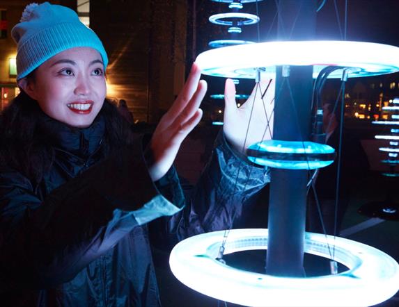 Visitors enjoying 'Illumaphonium: halo' interactive light and sound installation in Newry City this February.