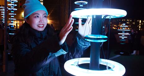 Visitors enjoying 'Illumaphonium: halo' interactive light and sound installation in Newry City this February.