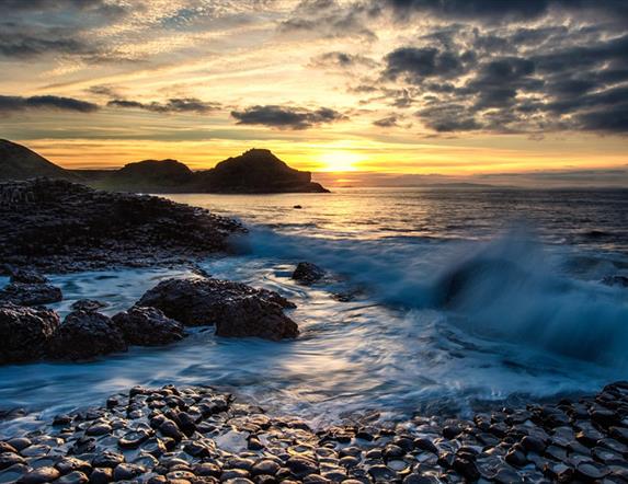 waves lap over the basalt stones at the giants causeway