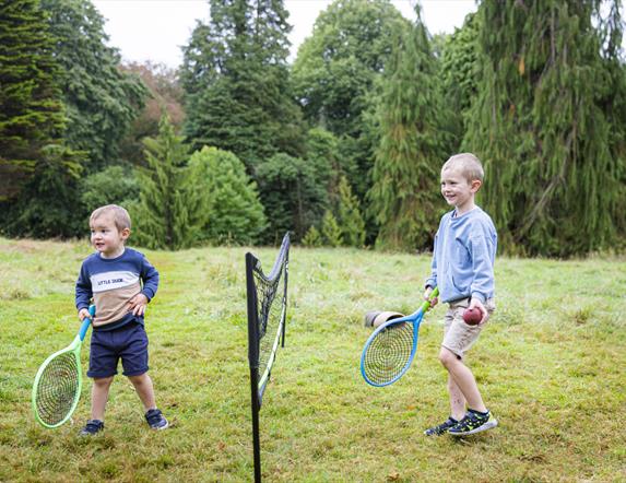 Two boys playing tennis at Rowallane Garden