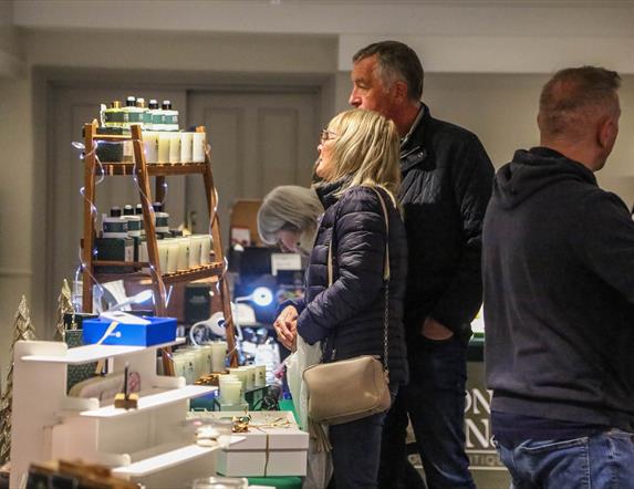 People browsing indoor market stalls