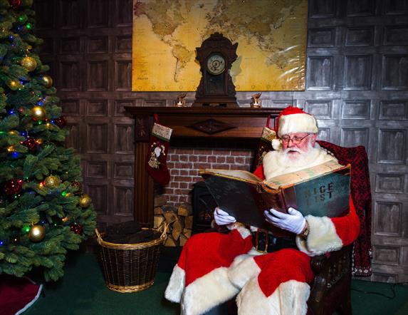 Father Christmas checking the Nice List