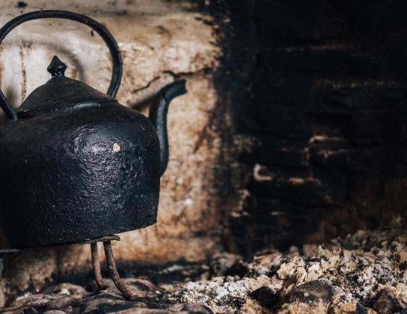 Image of kettle on the hearth at the Ulster American Folk Park