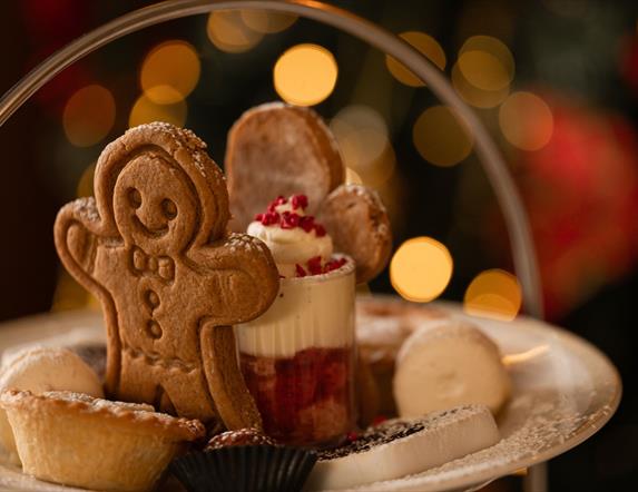 Plate with gingerbread person, mince pies and mini trifle