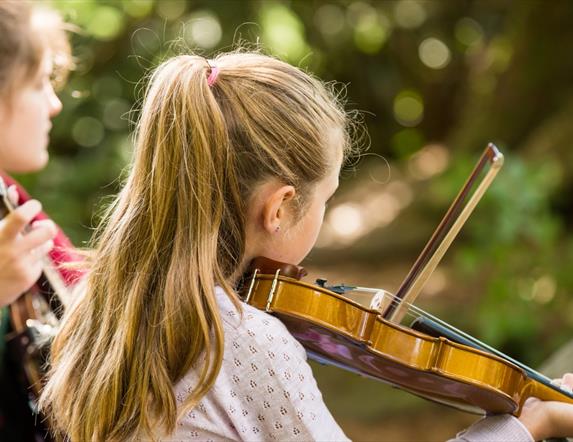 Homegrown Harmonies, two girls playing instruments. A Celebration of Traditional Music & Culture
