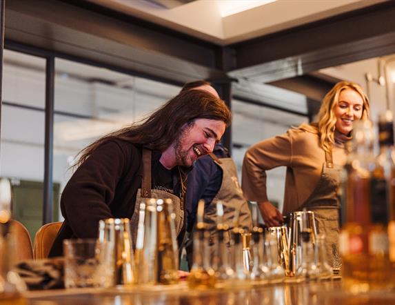 A couple preparing cocktails at McConnell's Distillery.