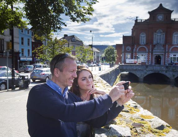 Couple taking a selfie (at Newry Town Hall) enjoying themselves on The Story of Newry Walking Tour.