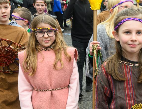 Performers walking down Market Street in Downpatrick as part of the St Patrick's Day parade.