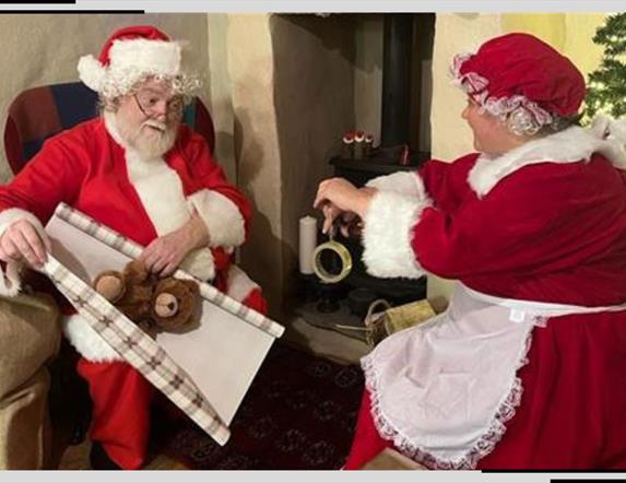 Santa and Mrs Claus wrap presents together
