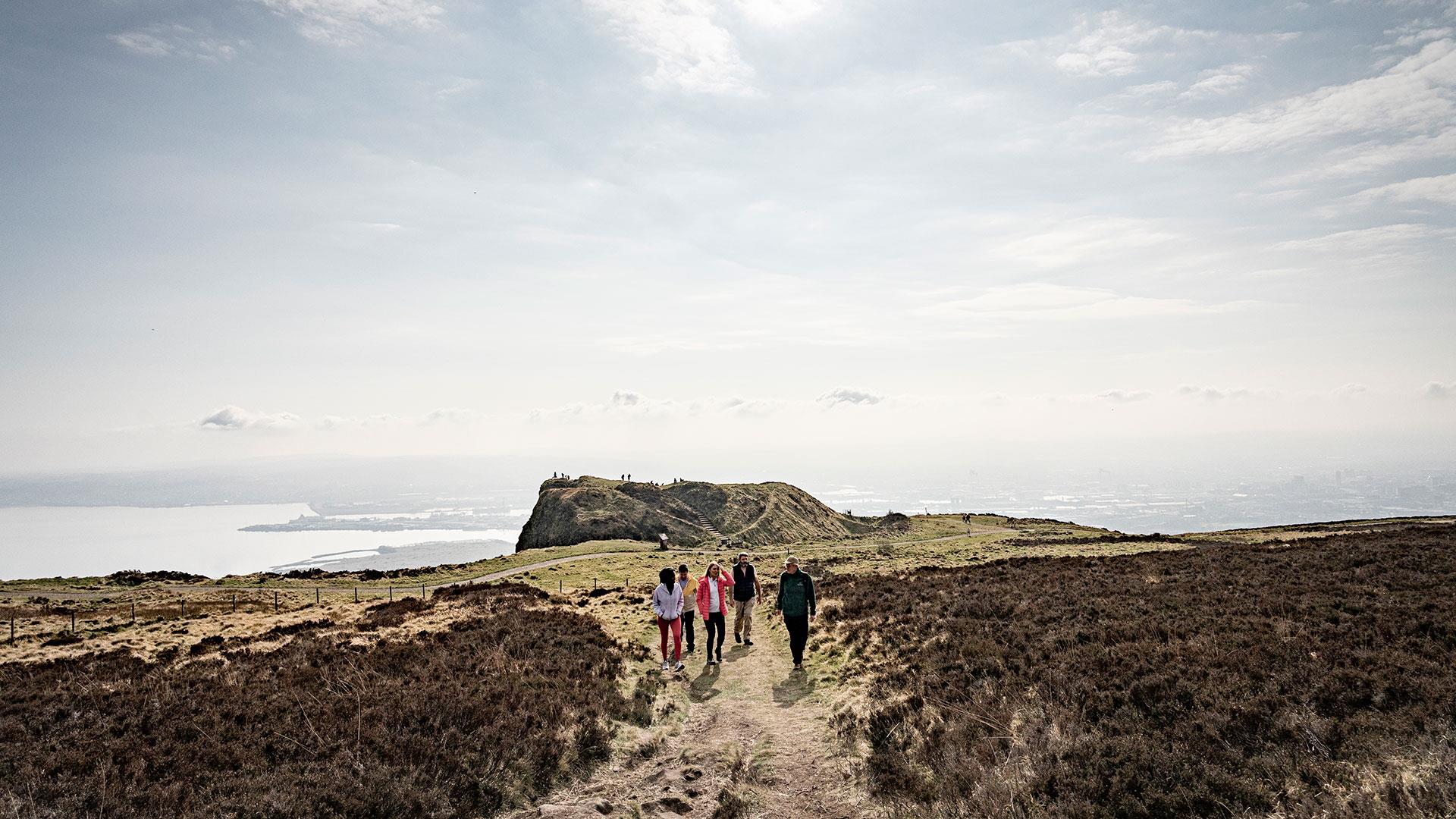 Group enjoying a walking tour on top of Cavehill in Belfast