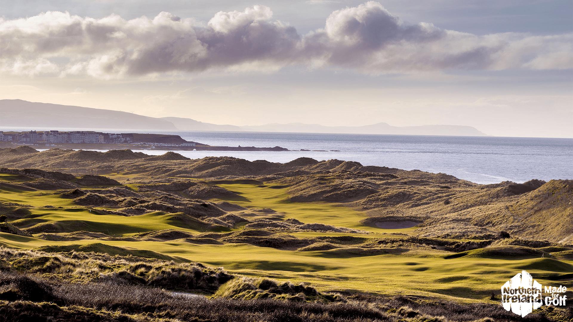 Aerial of the greens and fairways at Royal Portrush Golf Course overlooking the sea