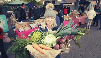 Image of Ashleigh from Cherry Valley Farm - a vegetable farm with market goings-on in the background