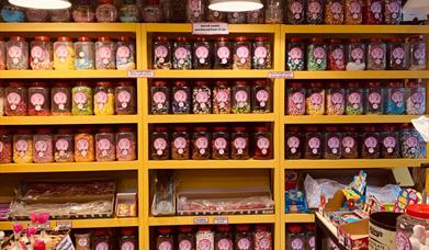 Shelves filled with jars of dozens of different home made sweets.