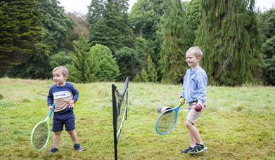 Two boys playing tennis at Rowallane Garden