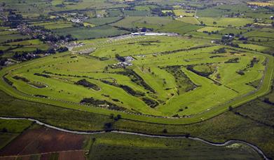 Shows aerial image of the whole golf course and surrounding countryside
