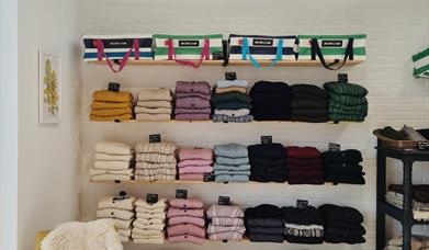 shelves at Bramble Green holding a range of colourful knitwear