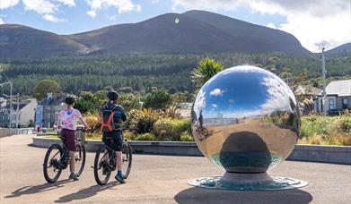 Cyclists on bikes from Bike Mourne, Newcastle admiring the Mourne Mountains from the Promenade, Newcastle, County Down