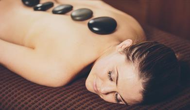 Lady enjoying a hot stone massage