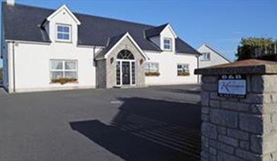 Outside photo of Kensington Lodge, white windows and black door