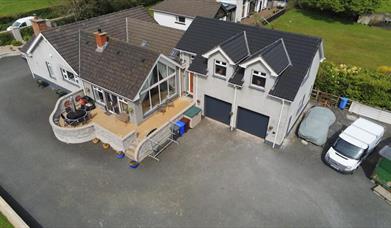 An arial view of a large country house with an annexe.