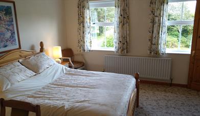 Double bedroom with radiator and 2 windows