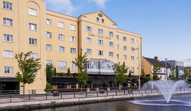 View of the front of the Canal Court Hotel and Spa building, fountain also in the picture.