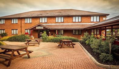 outside image of the Cohannon Inn with picnic tables to the front