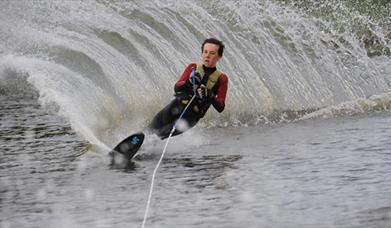Image is of a man water-skiing