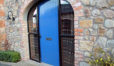 A bright blue door in an archway