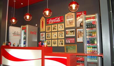 Image shows a drinks bar, fridge and counter top