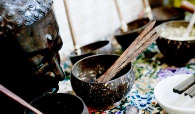 Statue and bowls with incense