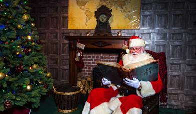 Father Christmas checking the Nice List