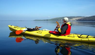 image of a young boy and a man in canoe out on the water