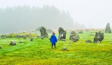 Young child on a misty morning walking through the Stone circles