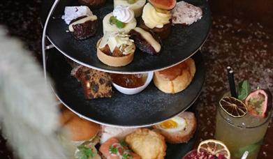 3 tier afternoon tea stand with savoury and sweet treats with cocktails & mocktails 