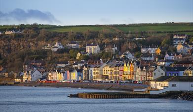 Whitehead promenade with coloured houses and old outdoor swimming pool