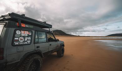 Land Rover Parked on Beach