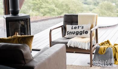 Armchair, stove and blankets in living area