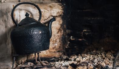 Image of kettle on the hearth at the Ulster American Folk Park