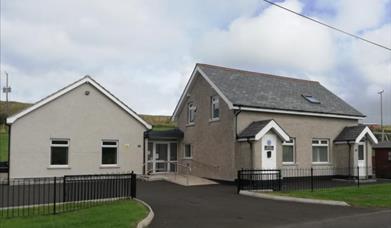 View of Dunluce Guide House from the front, further images of kitchen, TV room, twin room and dorm.
