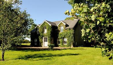 Exterior of Homeplace Retreat with large grass area