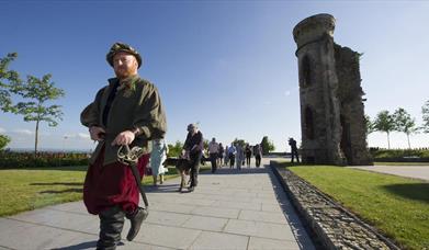 Man dressed in costume leading a group 